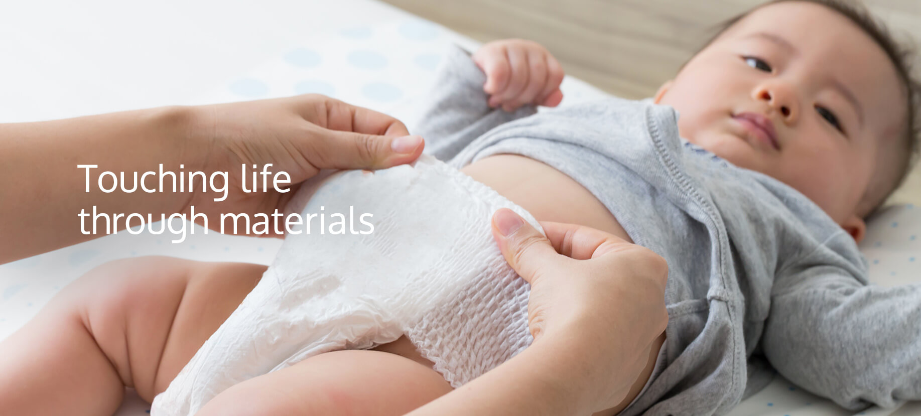 A parent's hands carefully changing a baby's diaper